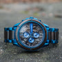 Orologio "Priamus" in acero e marmo, con un design blu sorprendente e dettagli quadrante intricati.