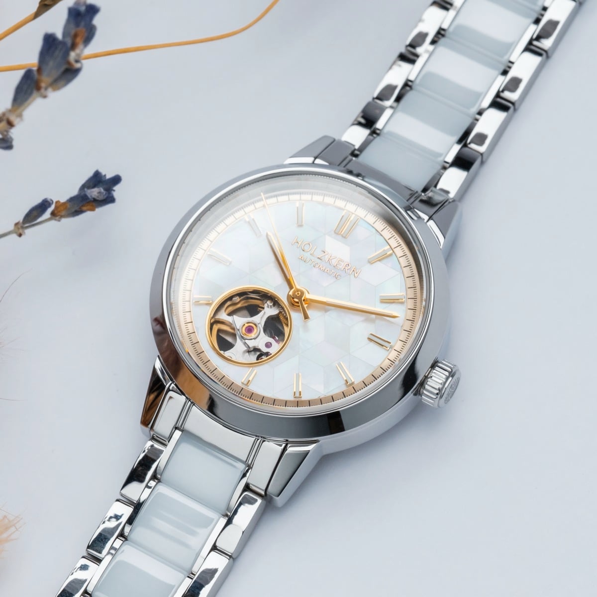 "Cristals" watch features a nacre ceramic design with a luxurious and elegant style.