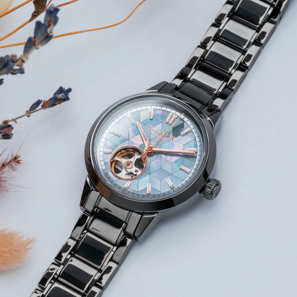 "Mirrordance" watch features a nacre ceramic face and sleek design, with a stylish metallic band.