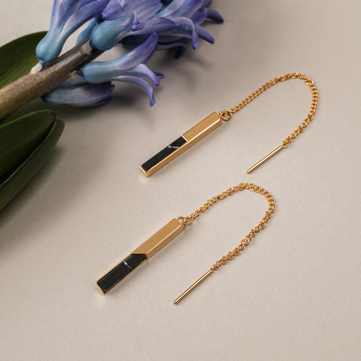 "Campania Earrings: Elegant marble and gold earrings with a sleek, modern design."