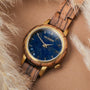 "Balos" watch features a zebrawood band and marble face, blending natural elegance with a unique visual style.