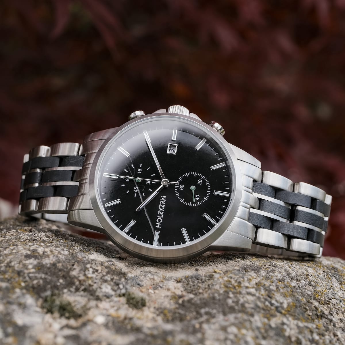 "The Observant watch, featuring a sleek black dial and stainless steel bracelet, exudes a modern and elegant style."