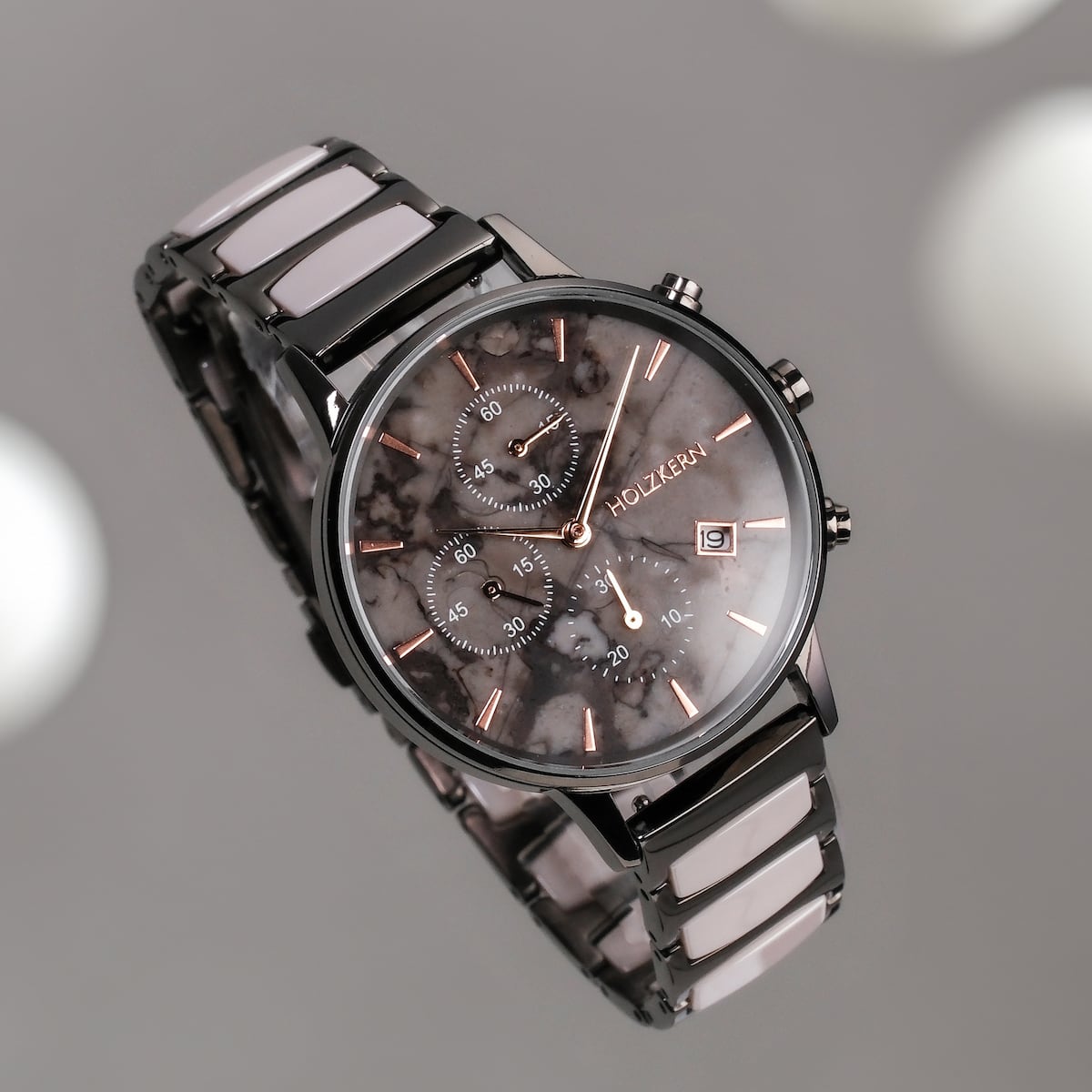 "Breezy watch featuring a marble-style dial and ceramic accents with a sleek, sophisticated design."