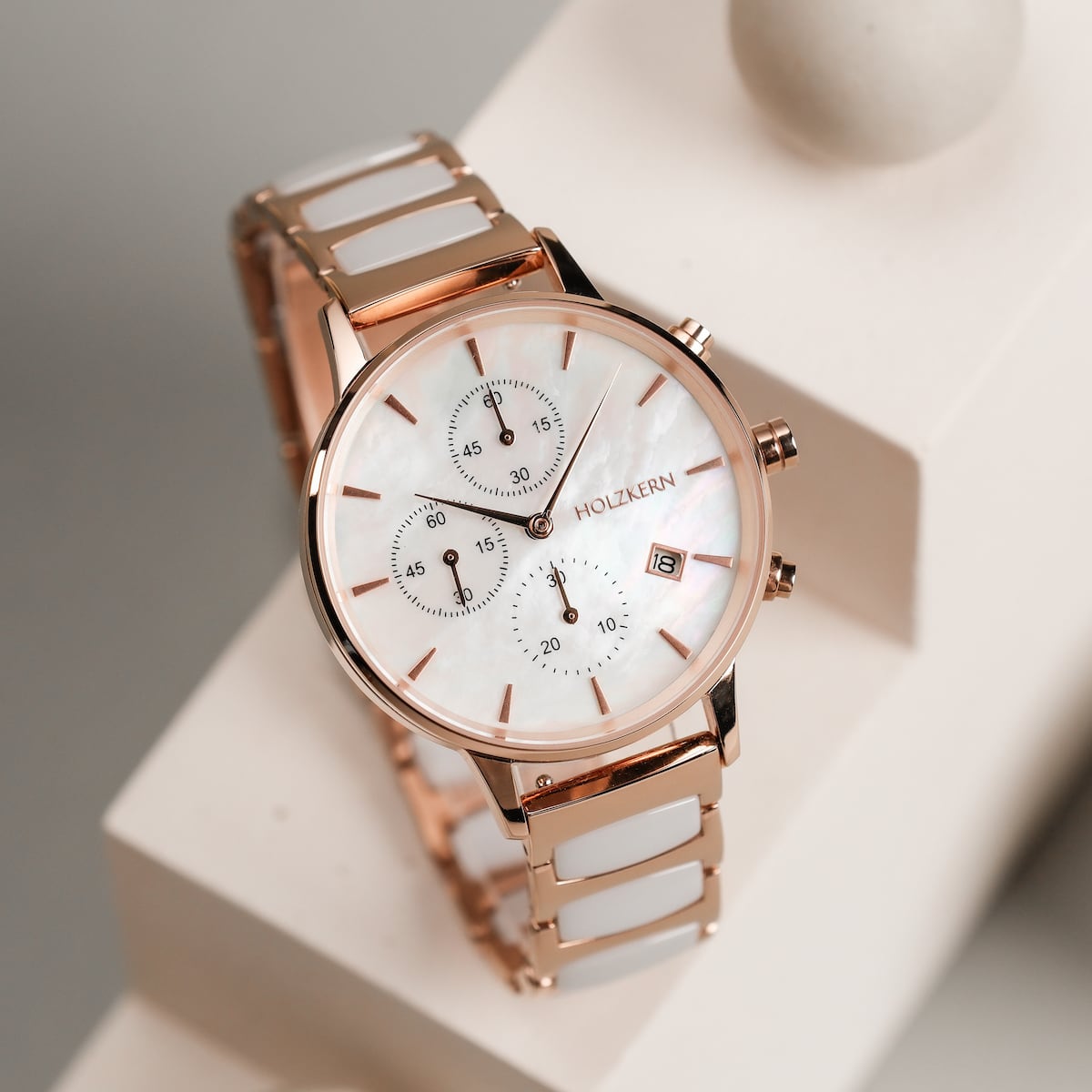 "Shiny" watch, featuring a nacre dial and ceramic inlay, with a sleek, modern design.