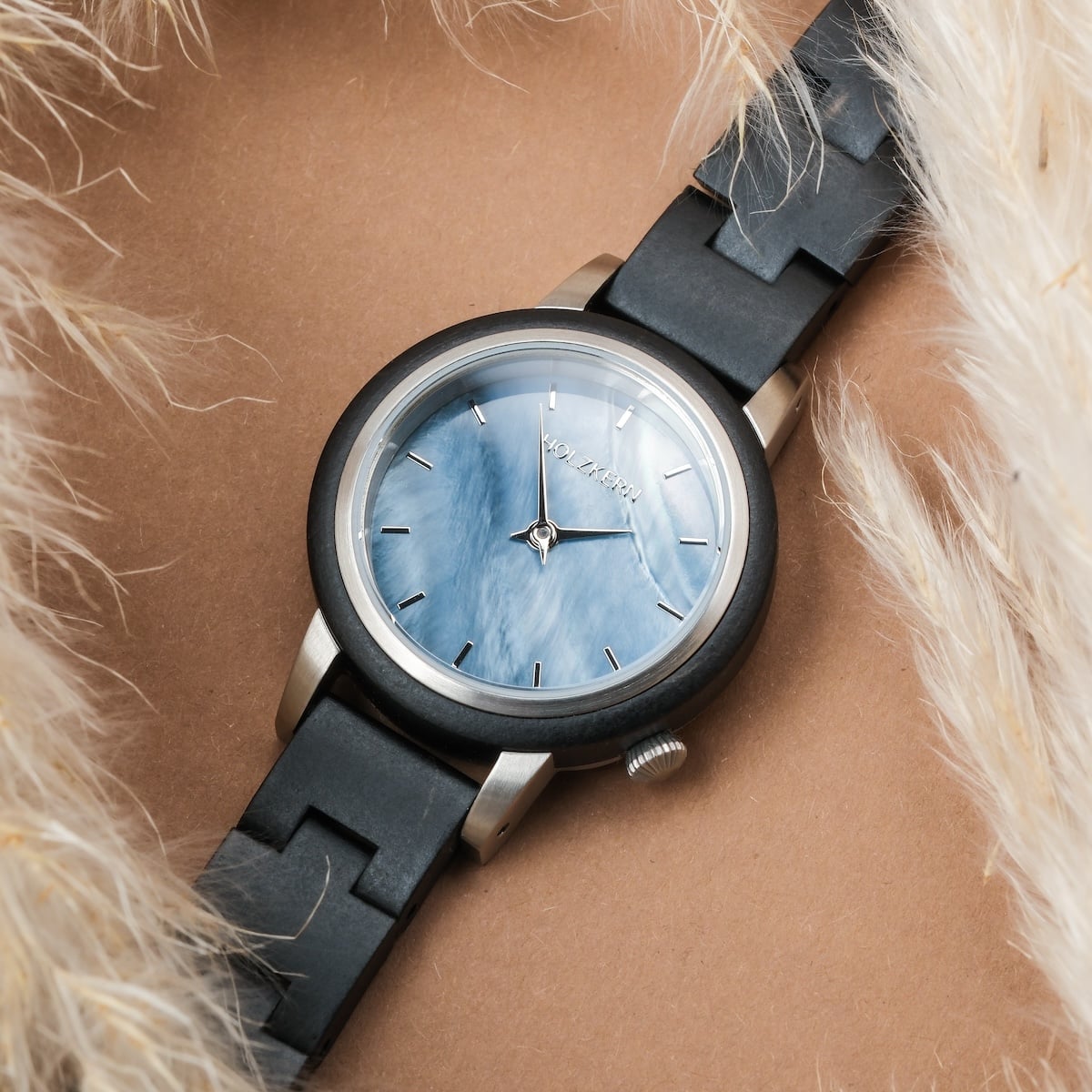 "Big Sur" watch featuring maple wood and nacre, elegant design with a sleek black and silver aesthetic.