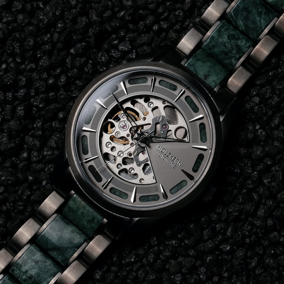 "Acraman", a watch featuring a marble band and dark grey dial with a skeleton design.