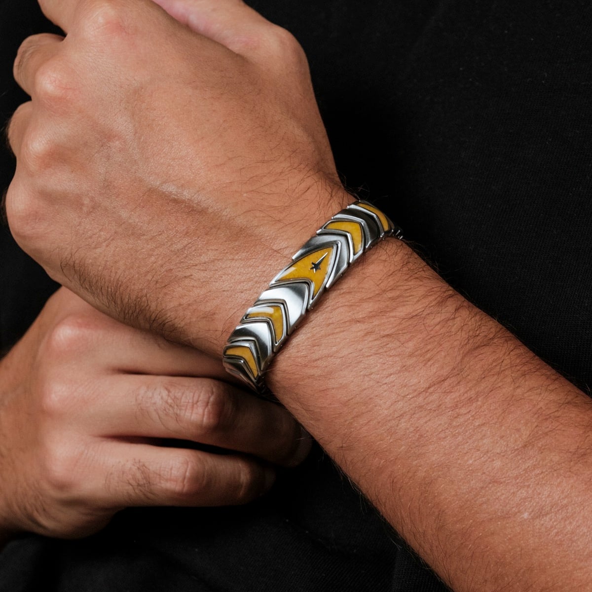 "Command" bracelet, featuring a sleek jade and silver design with chevron details.