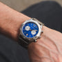 "Osprey watch with a striking azure blue face and classic silver-tone detailing."