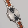 "Osprey watch with sleek stainless steel and wood accents in a modern design."