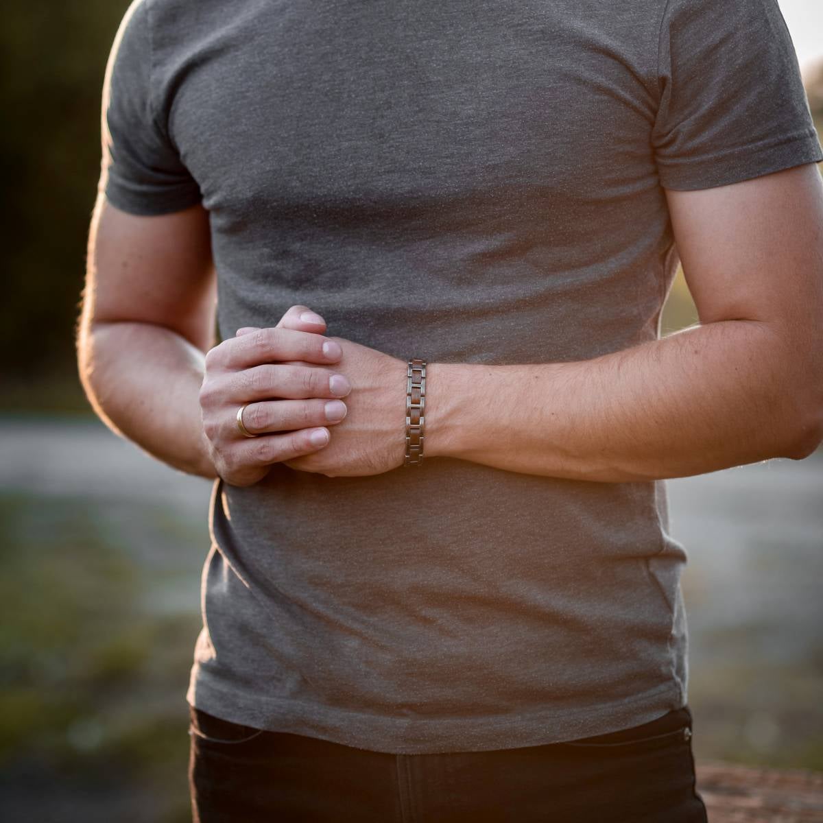 "Acoustic" bracelet in walnut and antique silver, styled on wrist.