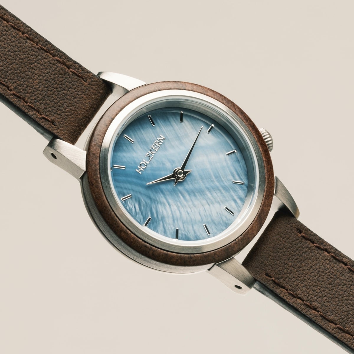 "Côte d’Azur" watch featuring a walnut and nacre design with a classic, elegant style.