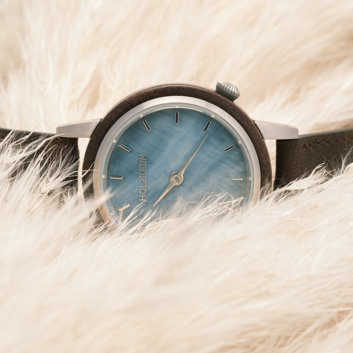 "Côte d’Azur" watch featuring a blue nacre dial and walnut accents, embodying elegant craftsmanship.