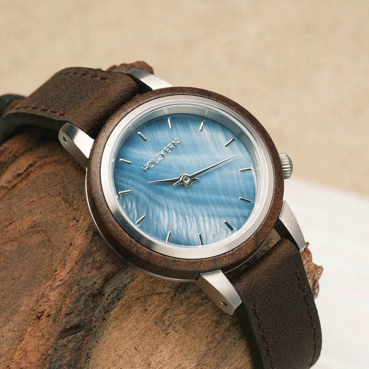 "Côte d’Azur" wristwatch featuring walnut wood and nacre details with a sleek, natural design.