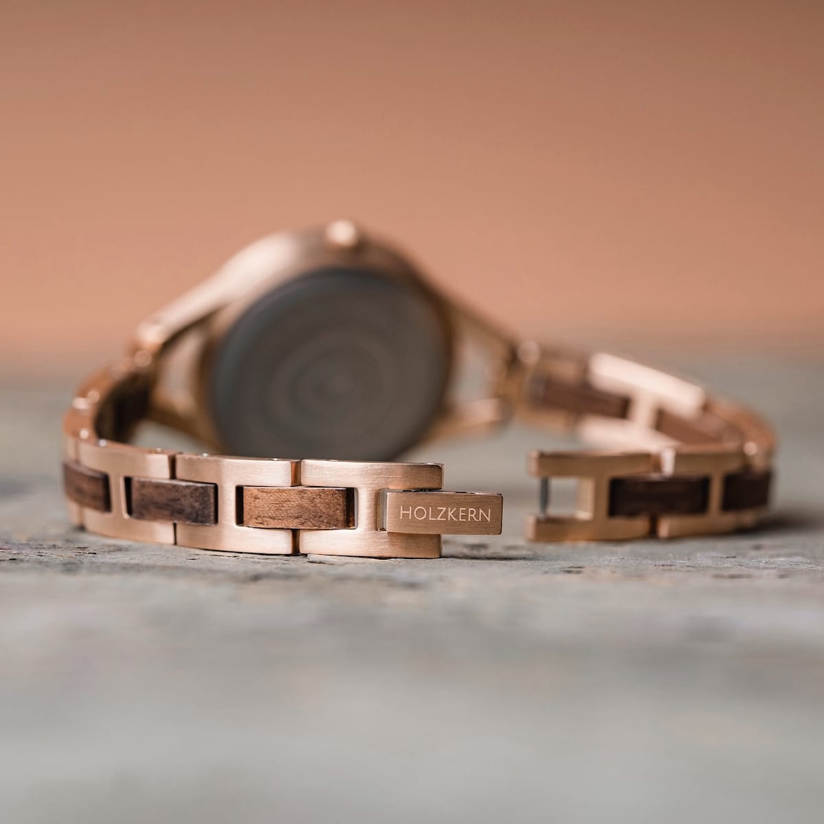 "Fatima" watch featuring a walnut and nacre design with a sleek metal bracelet.