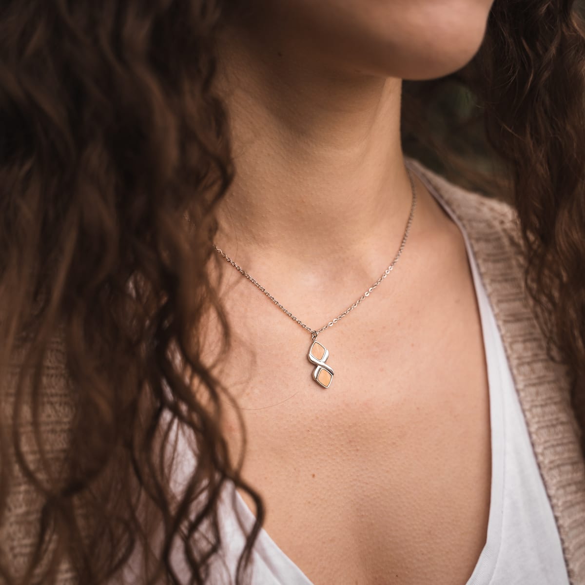 "Mosaic Necklace", a silver and olive mosaic necklace with a modern, elegant design.