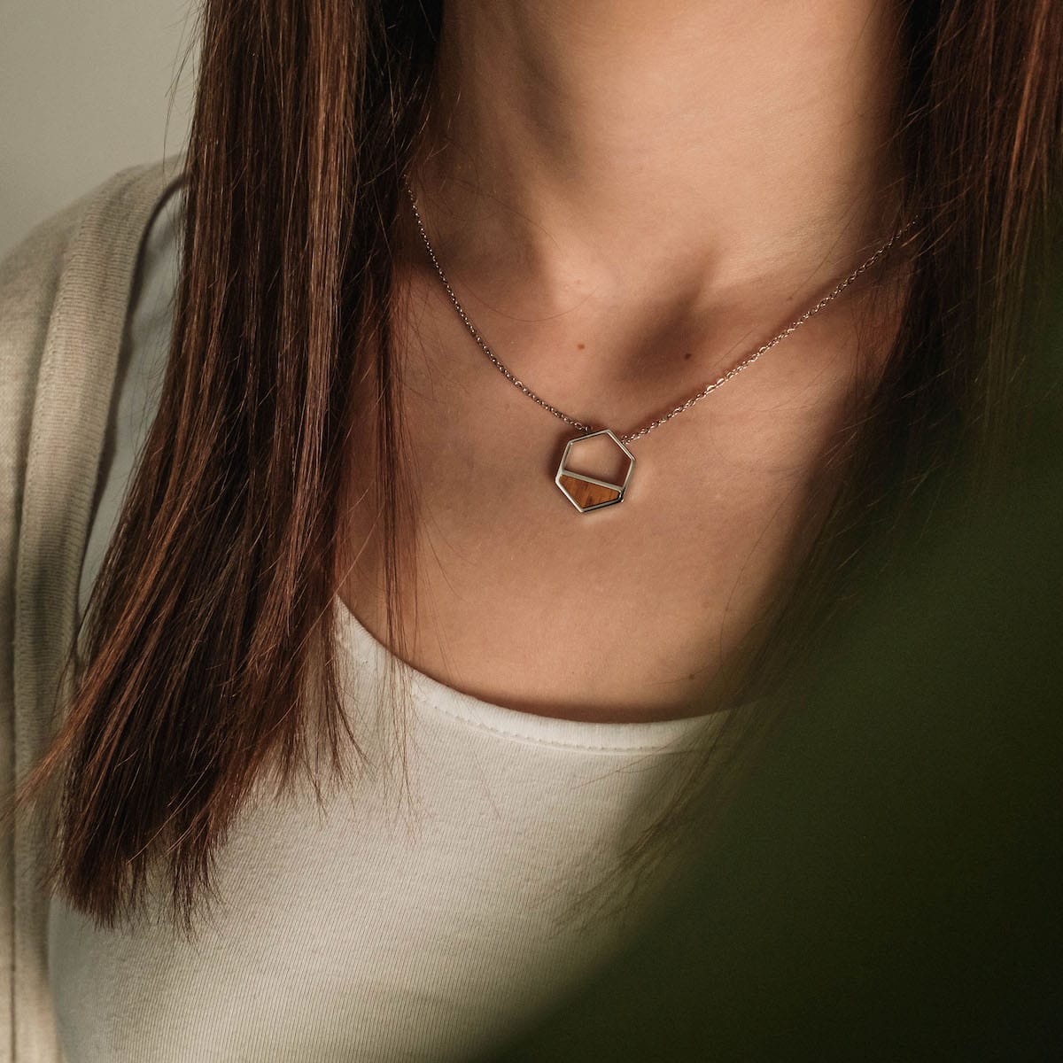 "Assemblage Necklace" necklace, featuring a geometric design with Koa wood and silver, worn elegantly for a stylish look.