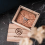 "Chiaroscuro Necklace, a necklace with gray marble and rose gold, displayed in a wooden box."