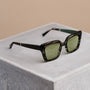 "The Exquisite sunglasses feature a classic square frame with a stylish Leadwood finish and Khaki Dust lenses on a neutral backdrop."