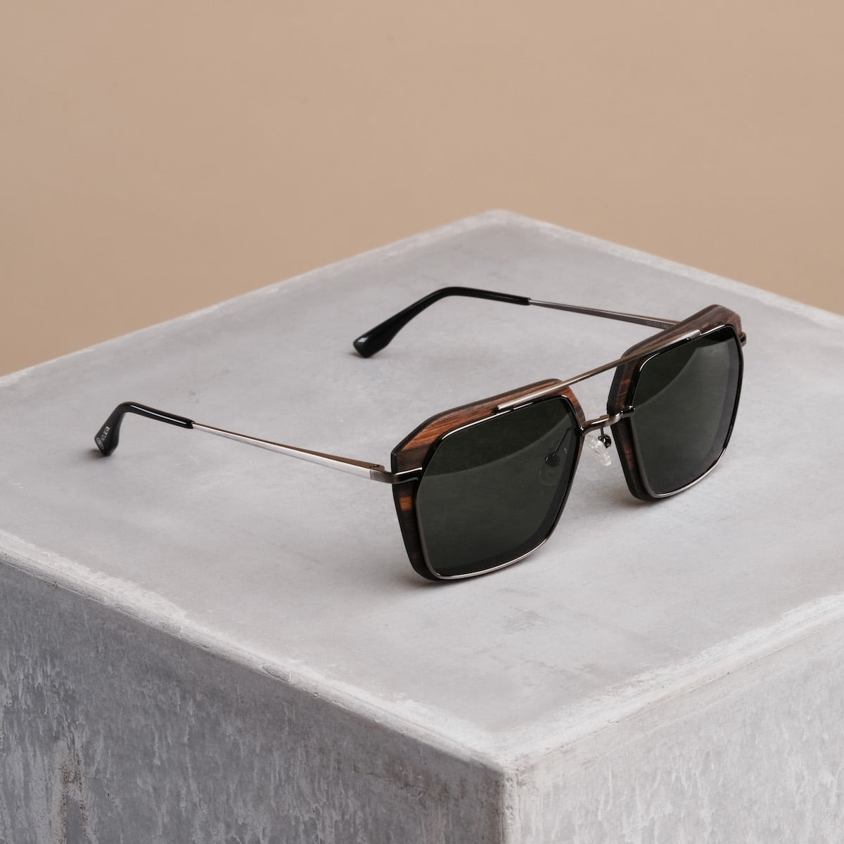 "The Storyteller sunglasses feature a Leadwood frame and Antique Silver accents, offering a refined and stylish look."