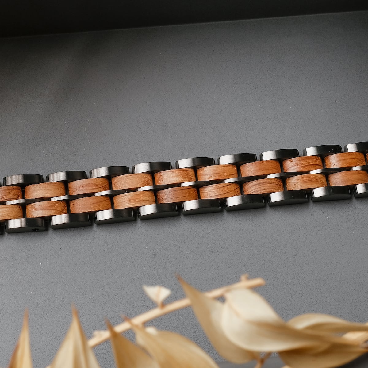 "Kanon" bracelet features oak and grey hues with a modern, woven design.