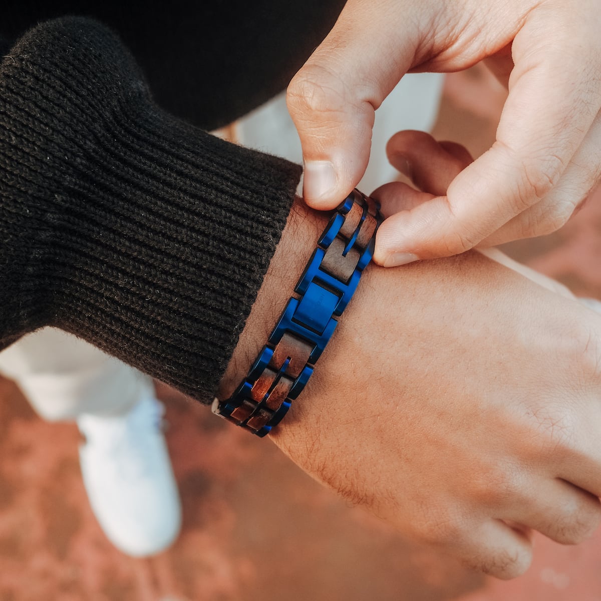 "Kanon" bracelet with walnut and blue accents, showcasing a sleek, modern style.