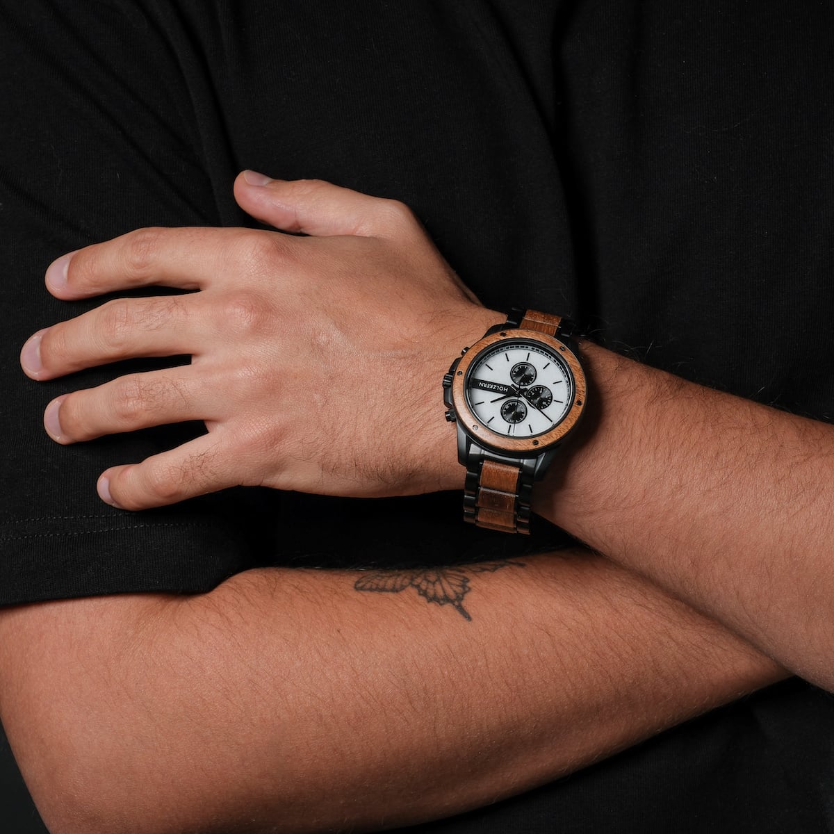 "Lancelot" watch with teak and marble finish, featuring a sleek, modern design on the wrist.