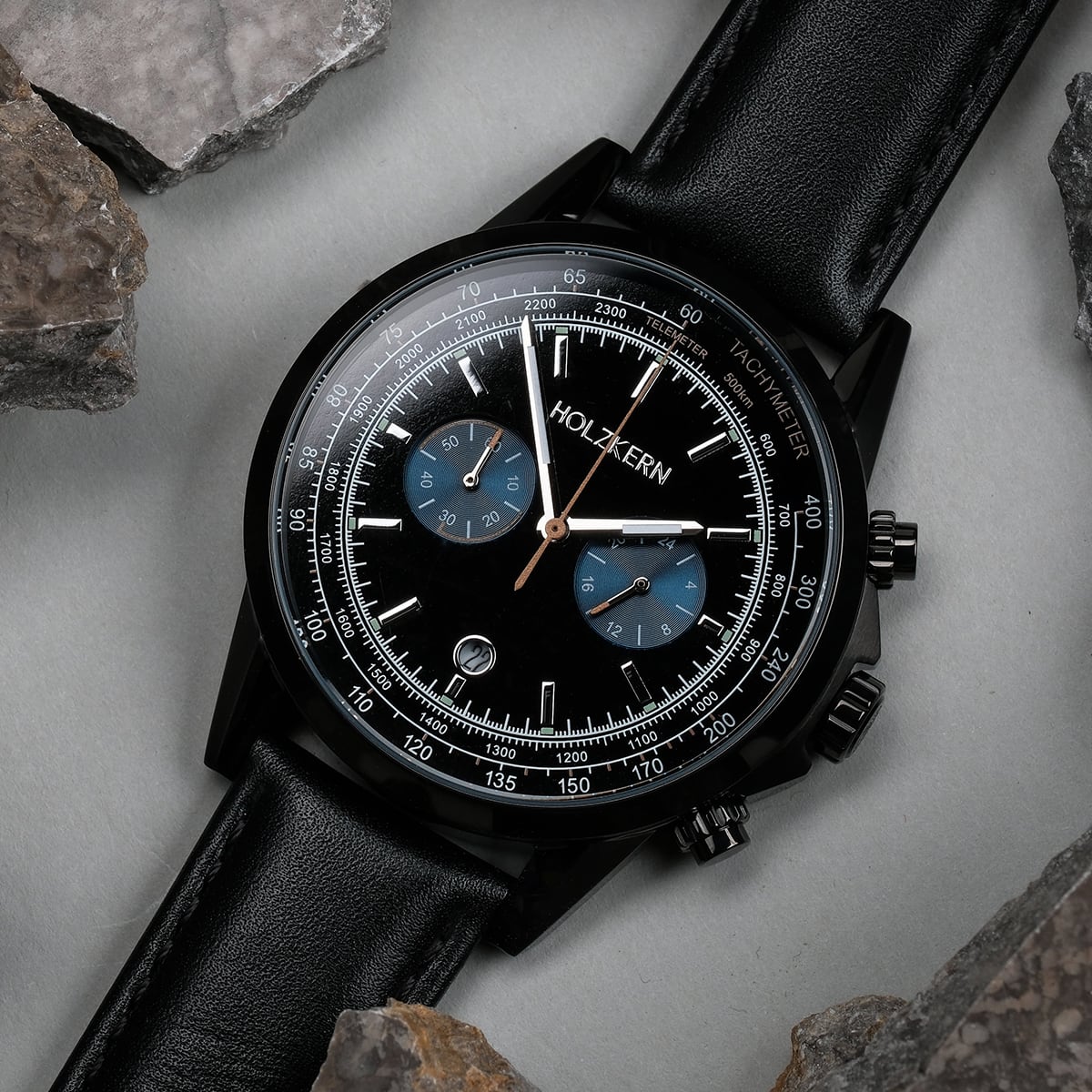 "Rackets watch, featuring a black dial and leather band, showcasing a sleek and sophisticated design."