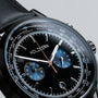 "Rackets watch with a sleek black design, featuring detailed dials and a tachymeter scale."
