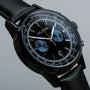 "Rackets watch with a sleek black dial and leather band, featuring a chronograph design."