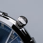 "Milestones watch with a stylish walnut and blue design featuring a detailed crown and sleek interface."