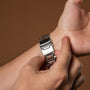 "Milestones wristwatch featuring a walnut and blue design with a sleek metallic band."