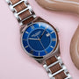 "Milestones, an elegant watch, features a walnut strap with a striking blue dial for a stylish look."