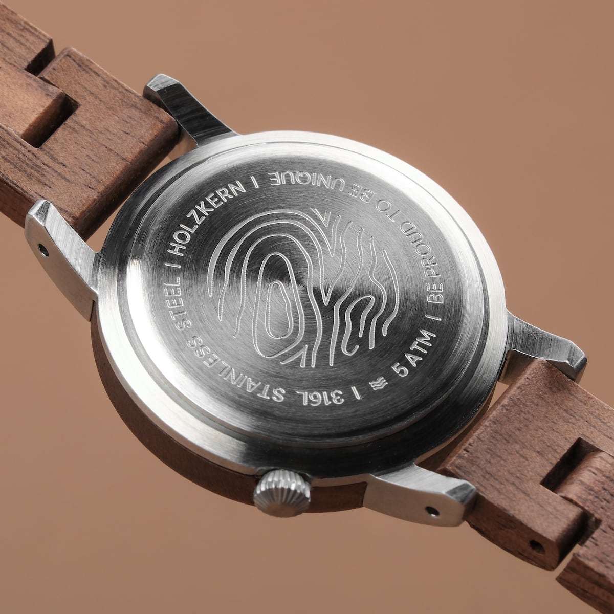 "Anakena" watch featuring a walnut band and marble accents with a sleek, minimalist back design.
