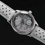 "DS9", wristwatch, featuring a marble-style face and light gray leather strap.