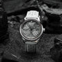 "DS9" watch features a marble-patterned dial and light gray strap, offering a sleek, modern aesthetic.