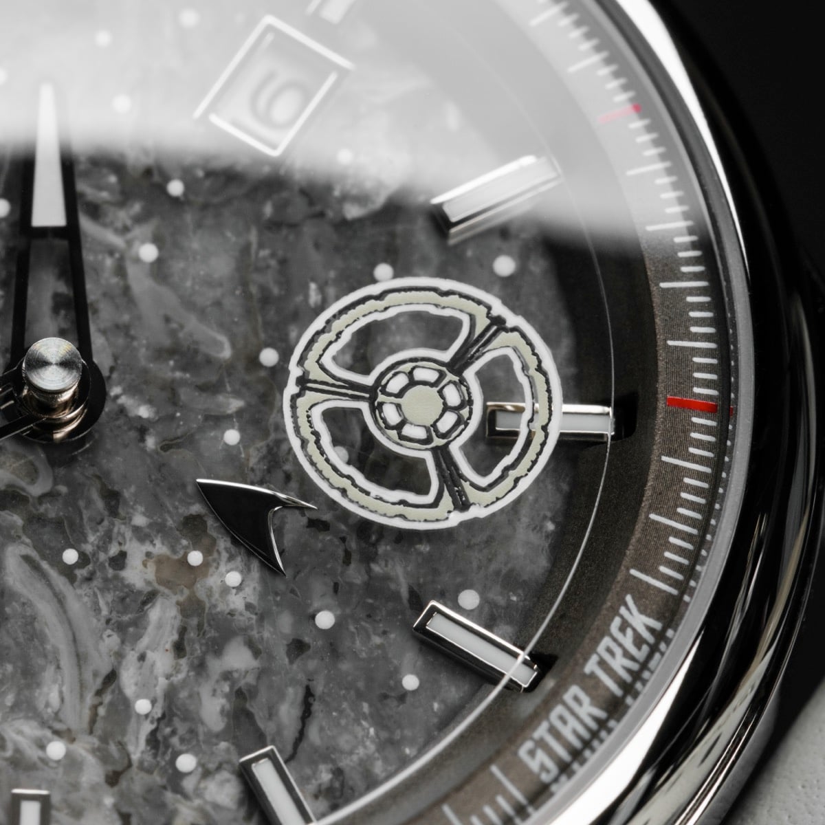 "DS9" watch with a marble and light gray dial, featuring sleek metallic accents and intricate detailing.