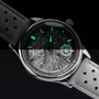 "DS9" watch featuring a marble-textured dial and light gray strap with luminous accents.