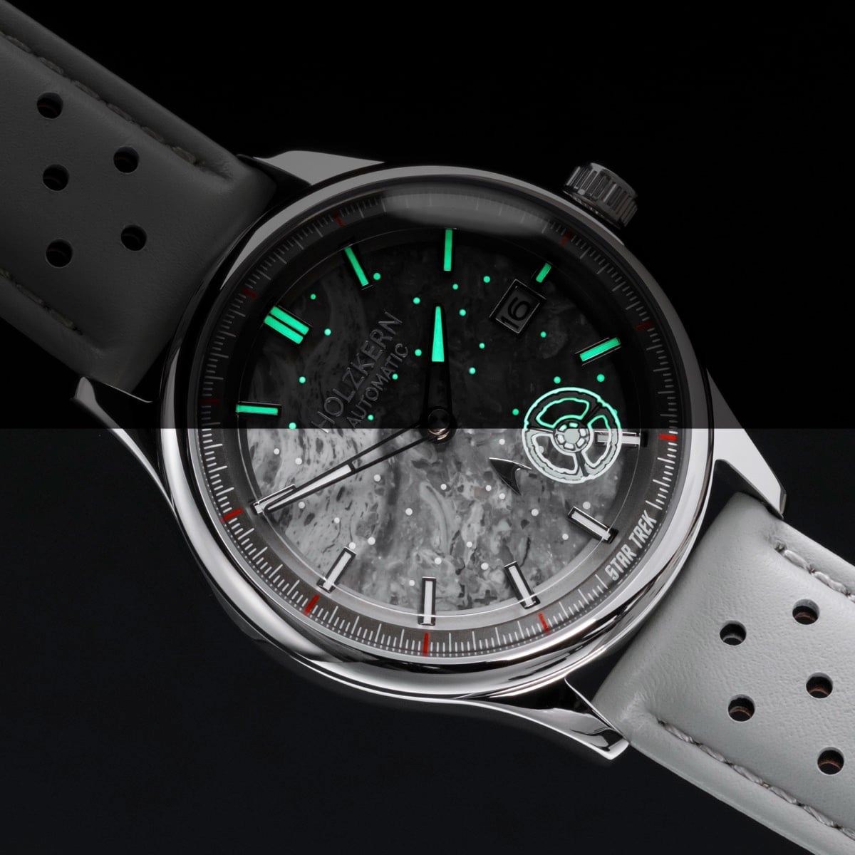 "DS9" watch featuring a marble-textured dial and light gray strap with luminous accents.