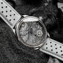 "DS9" watch featuring a marble-like dial and light gray strap with a sleek, modern aesthetic.