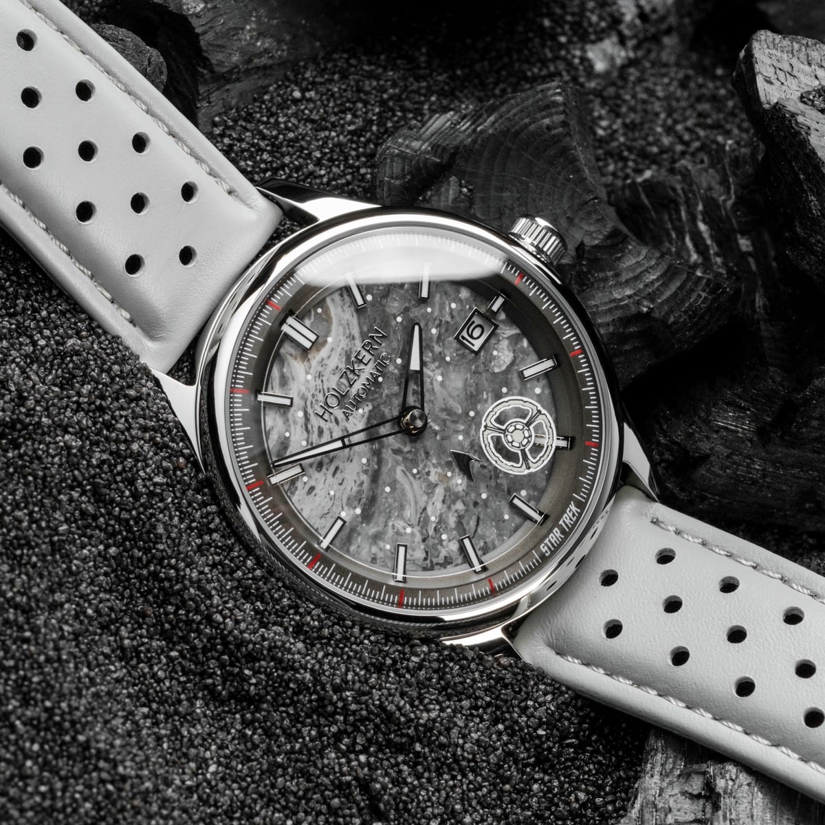"DS9" watch featuring a marble-like dial and light gray strap with a sleek, modern aesthetic.