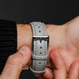 "DS9" wristwatch featuring a marble face and light gray leather strap with a sleek, modern design.