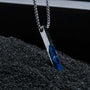 "Campania Necklace" necklace featuring a sleek design with sodalite and Damascus elements, set against a textured background.