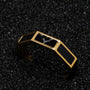 "Supremum Ring" ring, combines marble and gold elements with a modern, geometric design on a textured black background.