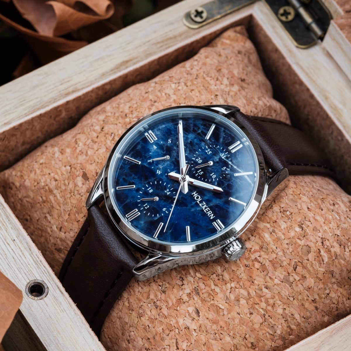 "Gifted" watch featuring a sodalite dial and dark brown leather strap in a wooden box.