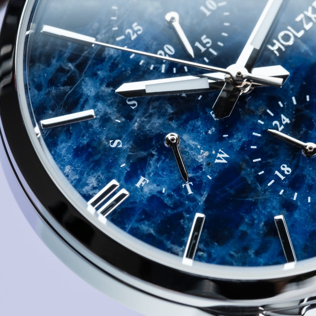 "Gifted" watch with a sodalite-style face and dark brown accents, featuring a sleek, modern design.