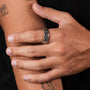 "Sumo Ring" ring crafted from oak and Damascus, showcasing a sleek, modern design.