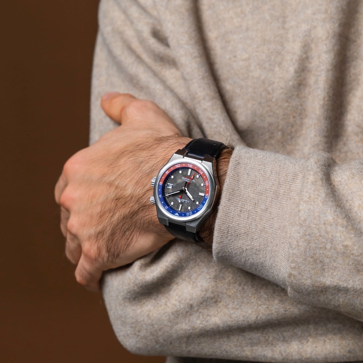 "GMT Cloudhopper" watch featuring a sleek marble and black design on a wrist.