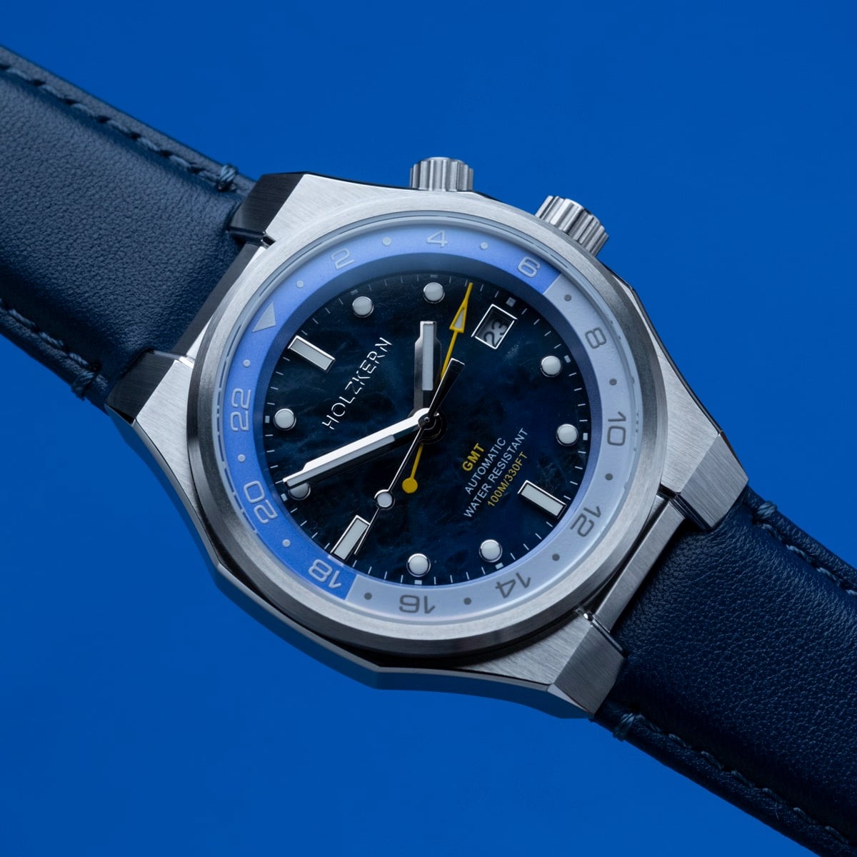 "GMT Cloudhopper" wristwatch features a marble and blue dial with a sleek, modern design.