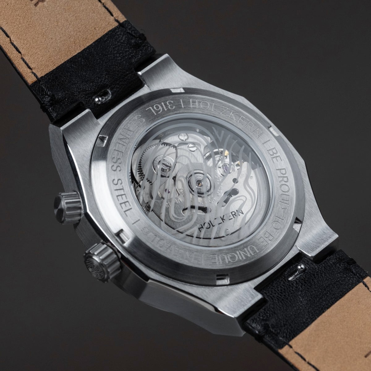 "GMT Cloudhopper" watch featuring a marble and black design with visible mechanical movement.