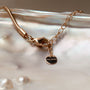 Collana "Amorance" con elementi in oro rosa e grigio con uno stile elegante e moderno.